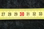 Centimeters Near A Tape Measure On The Number Thirty Stock Photo