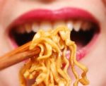 Woman Eating Noodles Stock Photo