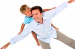 Father With Son On Back Stock Photo