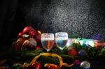 Two Glasses Of Champagne With A Christmas Decor In The Background Stock Photo