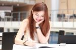 Portrait Of Thai Adult Beautiful Girl Write A Book And Smile In University Stock Photo