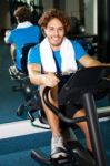 Handsome Man At The Gym Doing Static Cycling Stock Photo