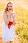 Lonely Beautiful Young Blonde Girl In White Dress With Straw Hat Stock Photo