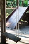 Empty Wooden Swing In The Garden Stock Photo