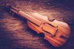 Violin On Grunge Dark Wood Background Stock Photo