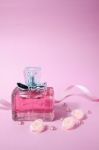 Pink Aromatic Perfume With Pink Pearls And Pink Textile Roses On Pink Background Stock Photo