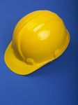 Yellow Hard hat On Blue Stock Photo