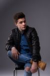 Casual Young Man In Black Leather Jacket And Denim Jeans Stock Photo