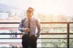 Businessman Using Mobile Phone In Outdoor Office Stock Photo