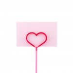 Pink Card In Heart Shaped Holder Stock Photo