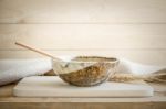 Brown Bowl With Spoon On Wooden Background Stock Photo