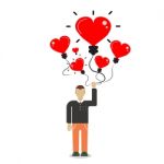 Man Holding A Balloon In The Form Of Heart Stock Photo