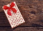 Heart Spot Present Gift Box With Red Ribbon On Old Wood Texture Stock Photo