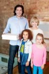 Little Girls With Parents Posing Casually Stock Photo