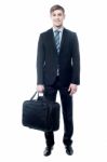 Businessman In Black Suit Posing With Bag Stock Photo