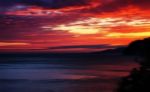 Horizontal Vivid Red Orange Vibrant Sunset Ocean Horizon Motion Stock Photo