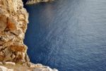 Rocky Coastline Overlooking A Blue Calm Sea Stock Photo