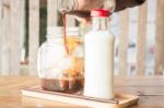 Pouring Espresso To Iced Glass Of Coffee Stock Photo