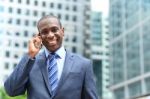 Smiling Businessman Talking On The Phone Stock Photo