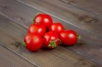 Fresh Tomatoes On The Dark Wooden Table Stock Photo