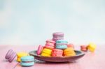 French Macarons On Pink Wooden Background. Vintage Style Stock Photo