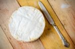 Camembert Cheese And Vintage Knife On Wooden Table Stock Photo