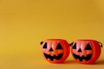 Pumpkins Bucket On Yellow Background , Halloween Background Stock Photo