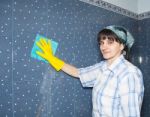 Woman Washes A Tile In The Bathroom Stock Photo