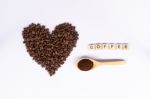 Top View Coffee Bean In Shape Of Heart With Wooden Spoon And Cof Stock Photo