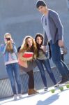 A Group Of Friends Having Fun With Skate In The Street Stock Photo