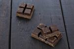 Dark Chocolate Pieces On Wooden Table Background Stock Photo