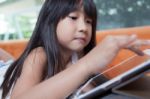 Girl Playing With Tablet Stock Photo