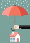 Hand Holding An Umbrella Protecting House Stock Photo