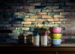 Colorful Tiffin Carrier And Plastic Bottles On Wooden Cupboard W Stock Photo