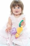 Smiling Toddler Holding Rattle Stock Photo