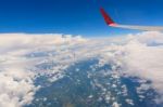 View From Airplane Window. Wing Of An Airplane Flying Above The Stock Photo