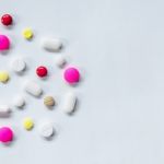 Top View Of The Pills On The White Background, The Drug And Capsule Pills On The Floor Stock Photo