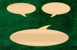 Wooden Speech Bubble On Green Cement Background Stock Photo