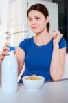 Woman With Cereal And Milk Stock Photo