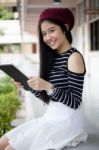 Portrait Of Thai Teen Beautiful Girl Using Her Tablet Stock Photo