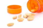 Closeup Of Orange Pills And Pill Bottle Stock Photo