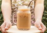 Hand Hold Glass Of Iced Coffee With Vintage Filter Effect Stock Photo