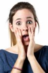 Young Surprised Woman Holding Her Face Stock Photo