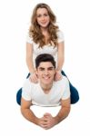 Pretty Girl Riding On Her Boyfriend's Back Stock Photo