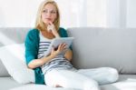 Pretty Young Woman Using Her Digital Tablet At Home Stock Photo