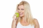 Health Conscious Woman About To Take Bite From Green Apple Stock Photo