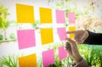 Close Up Shot Of Hands Of Woman Sticking Adhesive Notes On Glass Stock Photo