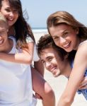 Young Women Enjoying Piggyback Ride Stock Photo