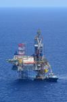 The Offshore Drilling Oil Rig And Supply Boat Side View Stock Photo