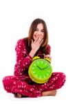 Teenager Sitting With Alarm Clock Stock Photo